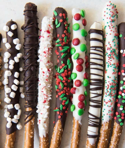 Chocolate covered pretzel rods dipped in sprinkles, candy, and cookies.