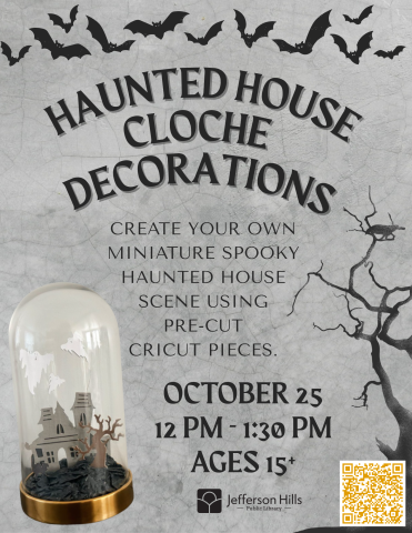 Spooky cloche decoration with bats, trees, and a house
