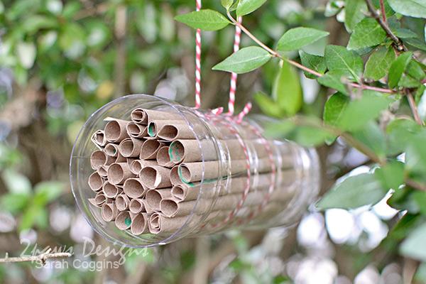 Bee hotel hanging from tree.